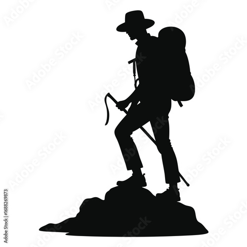 Silhouette of a hiker with a backpack and trekking poles on rocks