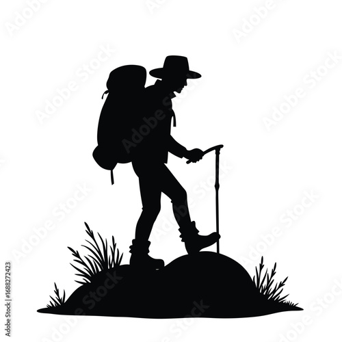 Silhouette of a hiker with backpack and trekking pole