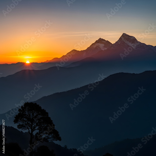 Majestic Mountain Range Silhouetted at Sunset with Golden Sky.