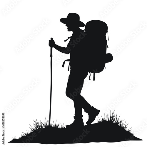 Silhouette of hiker with backpack and trekking pole on grassy hill