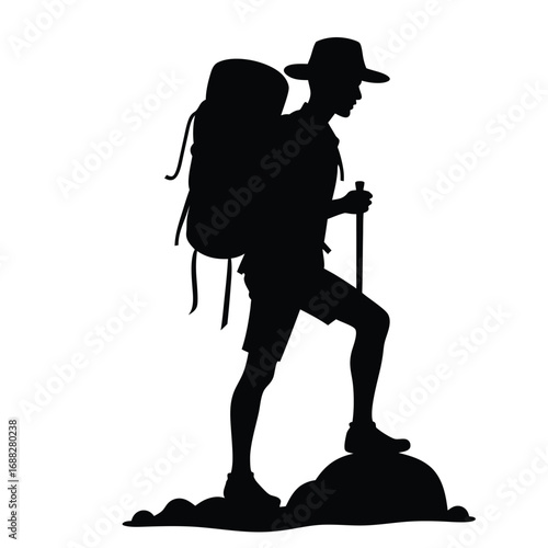 Silhouette of hiker with backpack and trekking pole on rocks