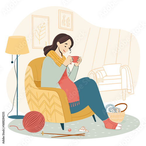 Woman relaxing in a cozy armchair with her knitting and a warm drink.