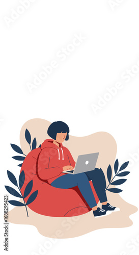 Young person in a red hoodie working on a laptop while comfortably seated on a bean bag chair. Ideal for remote work, study, or freelance concepts.