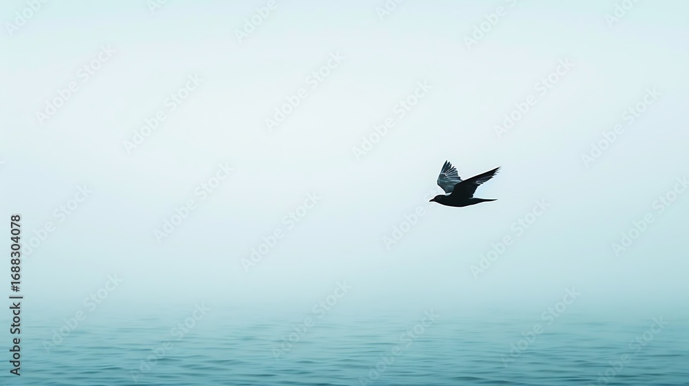 Naklejka premium Isolated bird flying high in empty pale sky, minimal negative space creating abstract serene atmosphere with clean modern background for typography use.