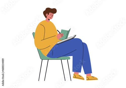 Young man thoughtfully journaling ideas and notes while sitting comfortably on a chair, capturing creative inspiration.