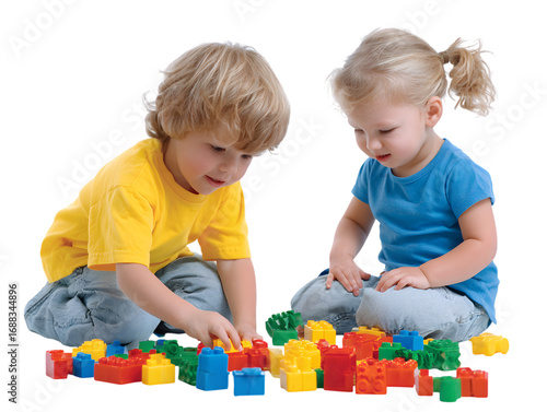 Two cute toddlers playing together with colorful building blocks.