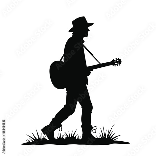 Silhouette of a man walking with a guitar and hat acoustic guitar