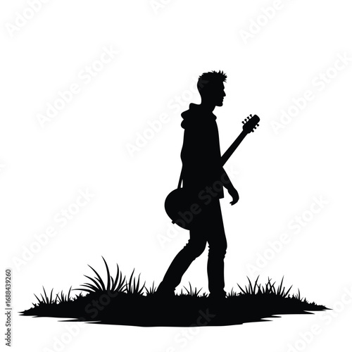 Silhouette of a young man walking with a guitar male