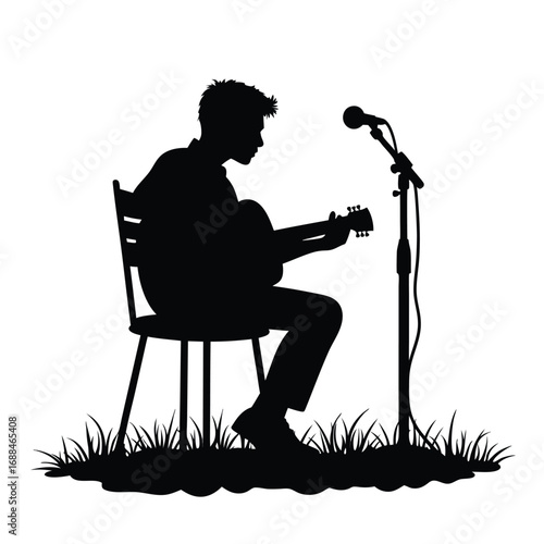 Silhouette of man playing guitar on chair with microphone