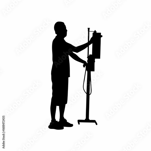 Silhouette of a technician adjusting a dialysis machine flow control knob