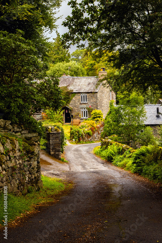 Country lane leading to a stone and slate-built cottage, Cumbria