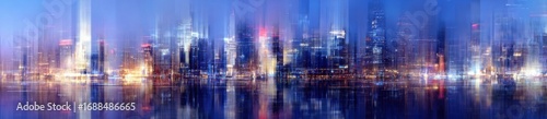 Abstract cityscape at twilight.  Blurred reflections of illuminated skyscrapers on a body of water.  Soft colors of blue, purple, and orange