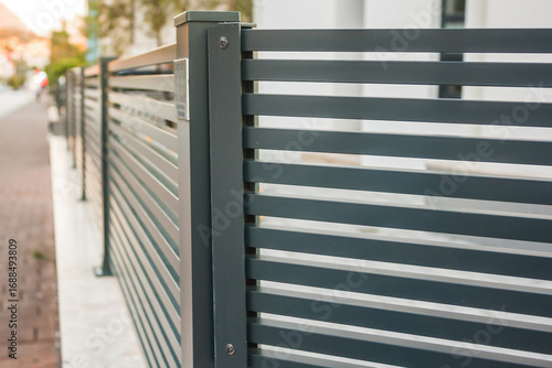 Modern stone fence with aluminum or metal shutter

