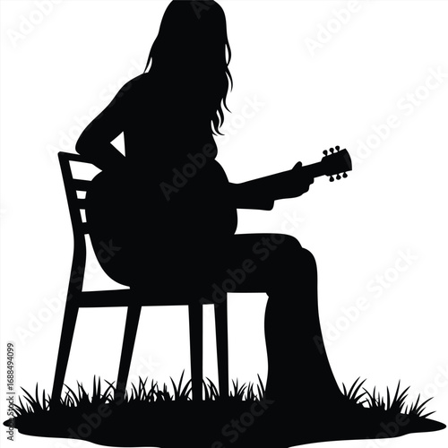 Silhouette of a woman playing acoustic guitar on a chair outdoors