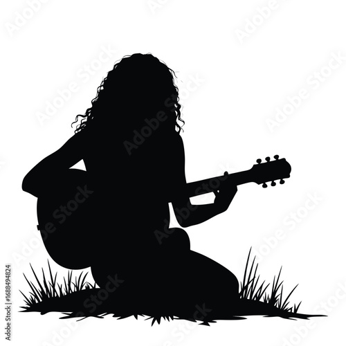 Silhouette of a woman playing acoustic guitar outdoors
