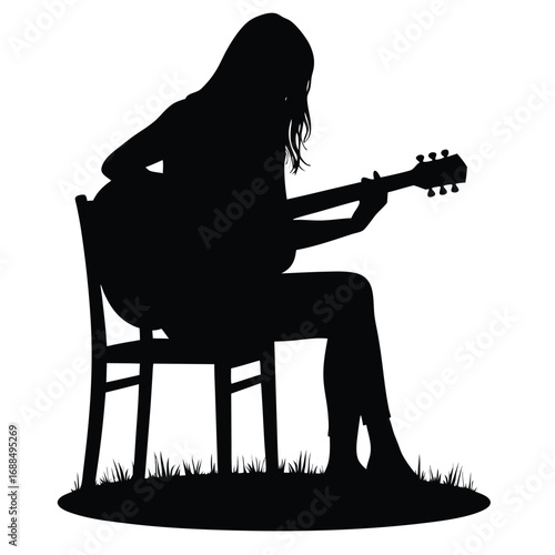 Silhouette of a woman playing acoustic guitar while sitting on a chair outdoors