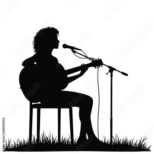 Silhouette of a woman playing guitar and singing into a microphone