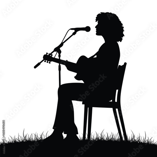 Silhouette of person playing guitar and singing into microphone outdoors 1