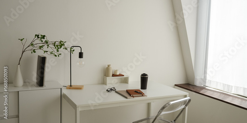 Konstfotografi white table beside window with a chair study lamp note book - study room