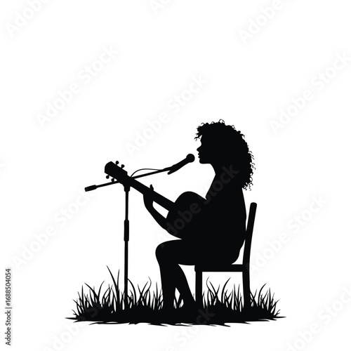 Silhouette of woman playing guitar and singing into microphone outdoors