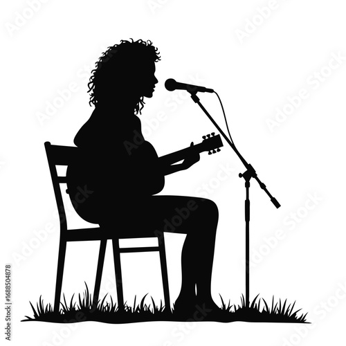Woman playing acoustic guitar and singing into microphone silhouette