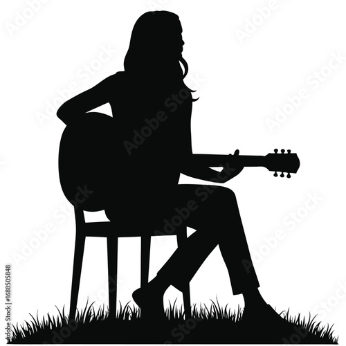 Woman playing acoustic guitar sitting on chair silhouette
