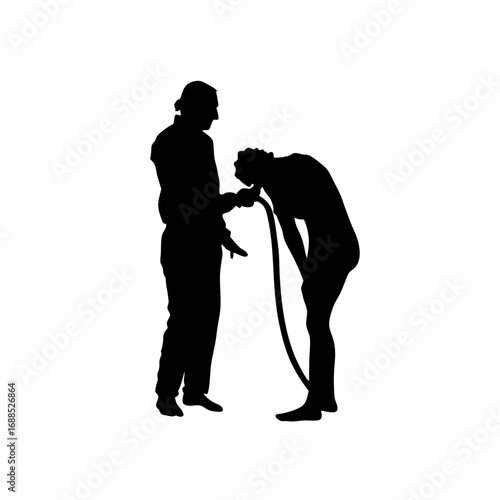 Silhouette of medical professional carefully removing tubing from patient