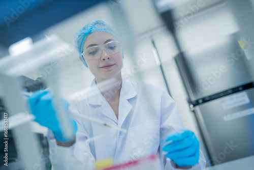 Scientist conducts research with pipette in a laboratory during daytime