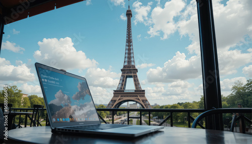 Eiffel Tower view with open laptop on café table.