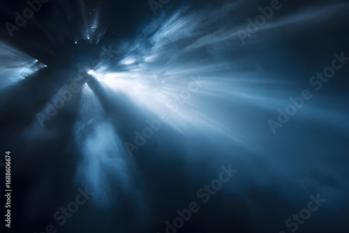 A beam of light shines through dark clouds at night.