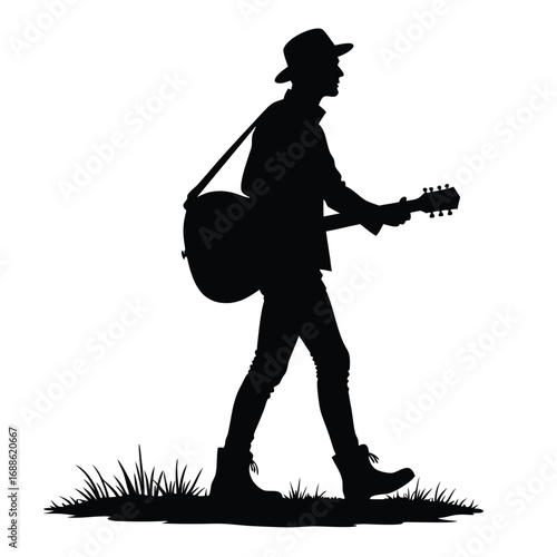 Silhouette of a man walking with a guitar and hat acoustic guitar