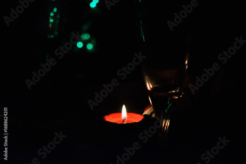 Red burning candle on dark background