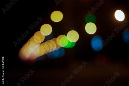 Colorful yellow-green lights in the night. Bokeh close up
