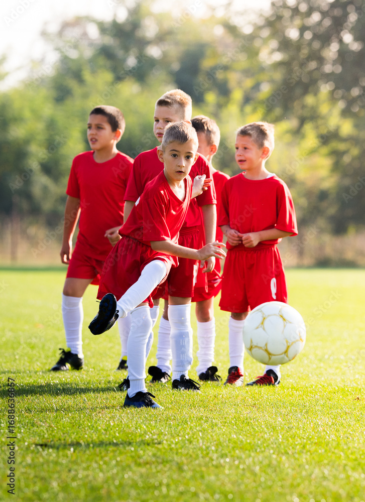 Obraz premium Boy Shooting at Goal