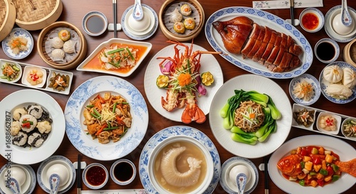 Fototapeta Naklejka Na Ścianę i Meble -  Top view of a lavish and diverse Chinese food banquet featuring a rich assortment of traditional celebratory dishes , plate styled for restaurant, advertising, and culinary magazine use