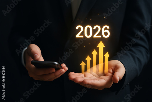 Businessman Holding Smartphone with 2026 Growth Chart Hologram