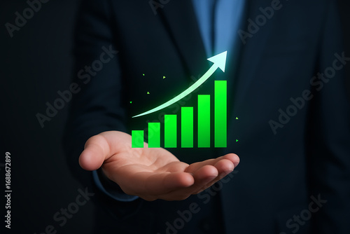 Businessman Holding Growing Bar Chart with Upward Arrow