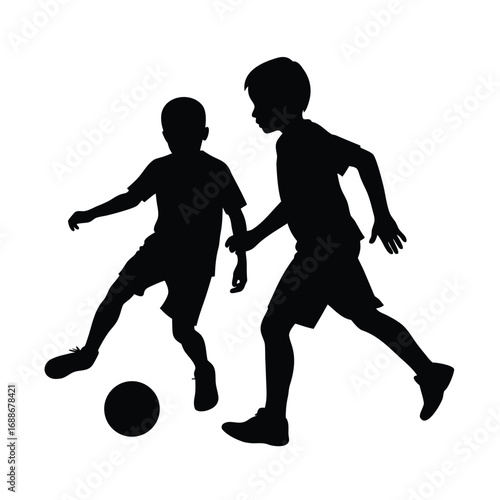 Silhouette of two young boys playing soccer