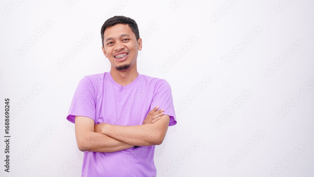 Obraz premium Happy confident Person. Portrait of smiling asian guy with folded arms looking at camera, wearing white shirt