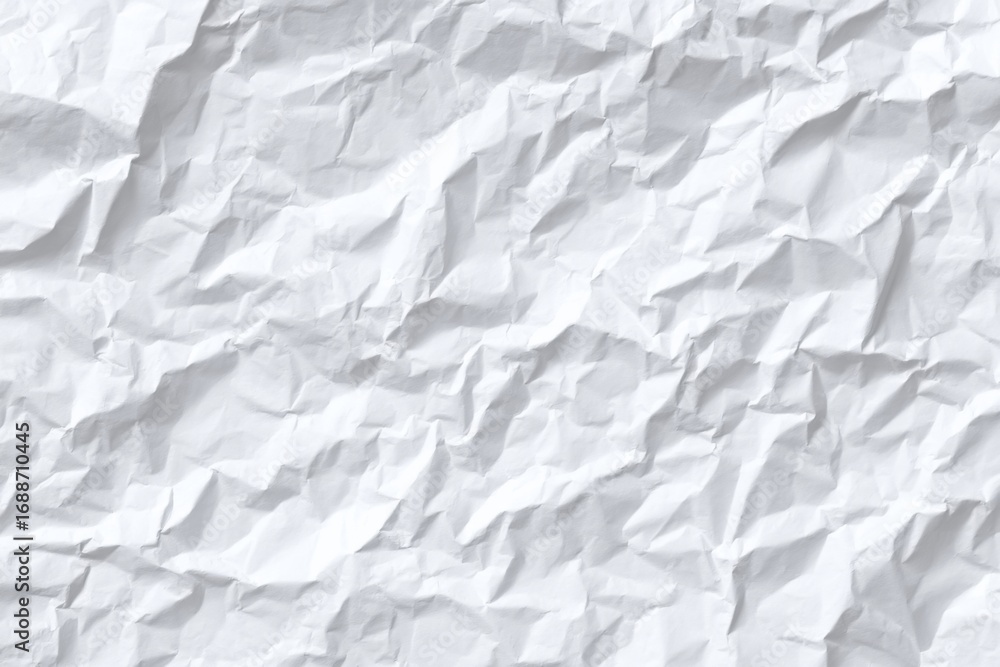 Obraz premium Close-up of crumpled white paper. Texture is uneven and deeply creased, showing folds and wrinkles. Light reflects subtly across the surface