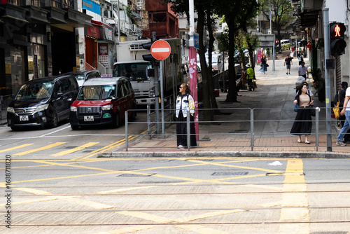 Wallpaper Mural View landscape building skyscraper cityscape house of HongKong city and life lifestyle local chinese people walking on street with traffic light at traffic road on April 26, 2025 in Hong Kong, China Torontodigital.ca
