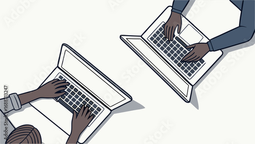 Overhead view of two people working on laptops collaborating remotely or in an office.