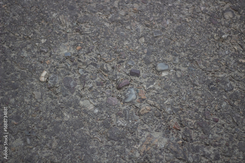 Closeup texture of asphalt with small pebbles and aggregate