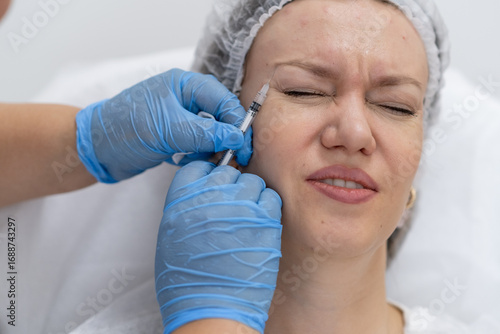 Botulinum Therapy Procedure Taking Place in a Clinical Setting With a Patient Undergoing Treatment