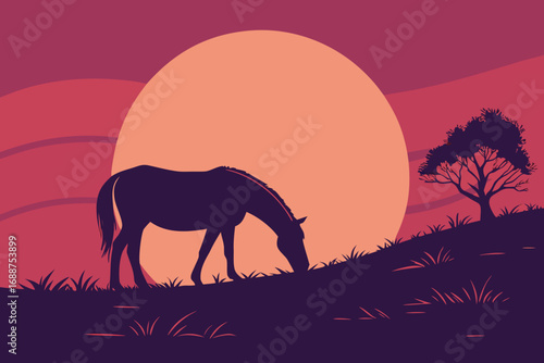Silhouette of a horse grazing on a hill against a large, vibrant sunset