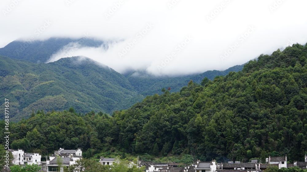 Obraz premium The beautiful mountains view with the covered fog on them