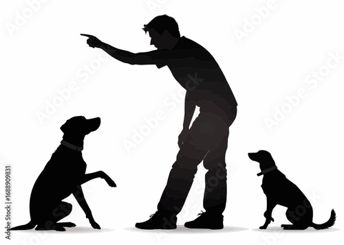 Silhouette of a man pointing at two dogs, one sitting and giving a paw, the other sitting attentively