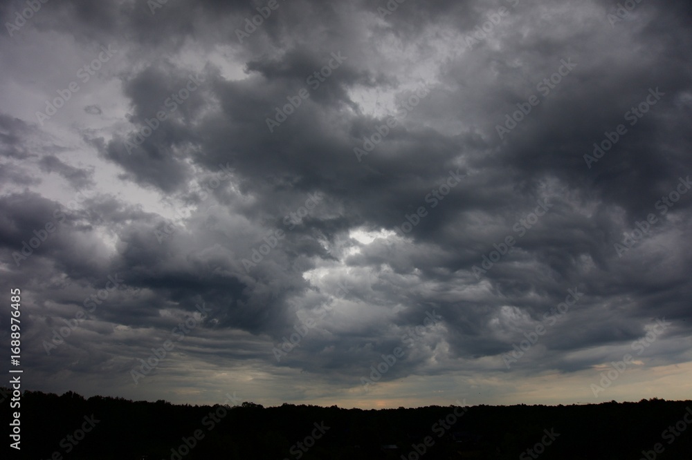 Obraz premium Clouds over the forest in summer