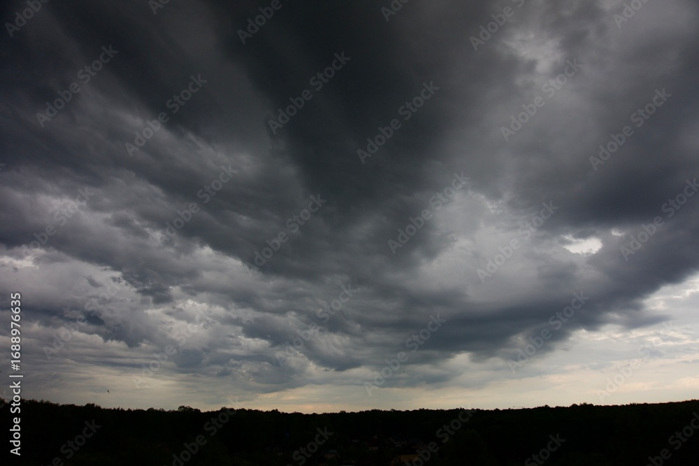 Fototapeta premium Clouds over the forest in summer