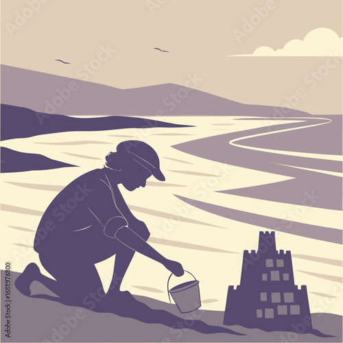 Child building sandcastle on a beach with mountains in background Keywords: beach, sandcastle